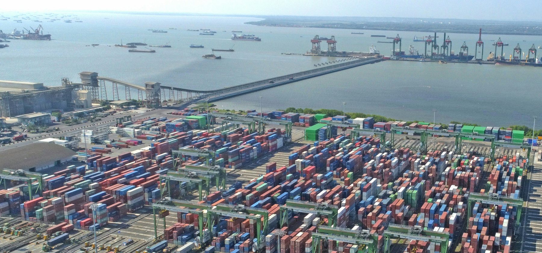 A global trade port with cranes and container yards