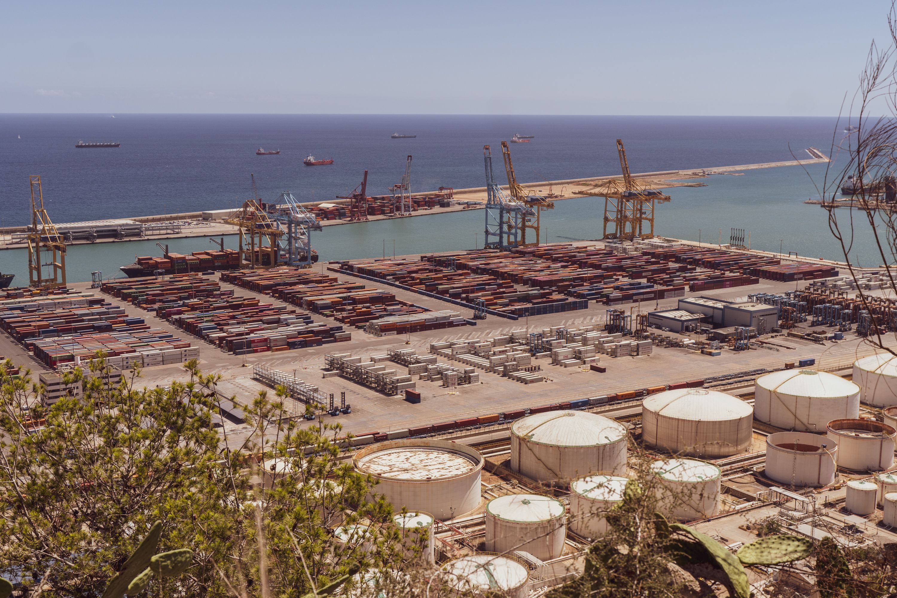 An international trade port with containers, harbor cranes and cargo ships