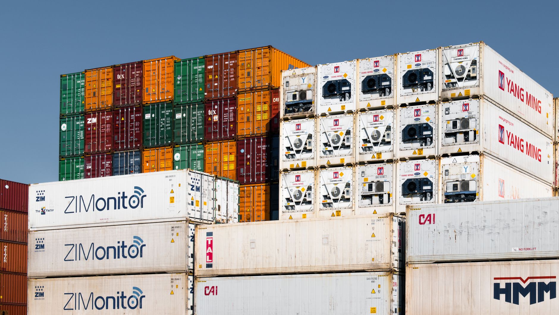 Colorful stacked shipping containers at Hamburg port, Germany, showcasing global trade logistics.