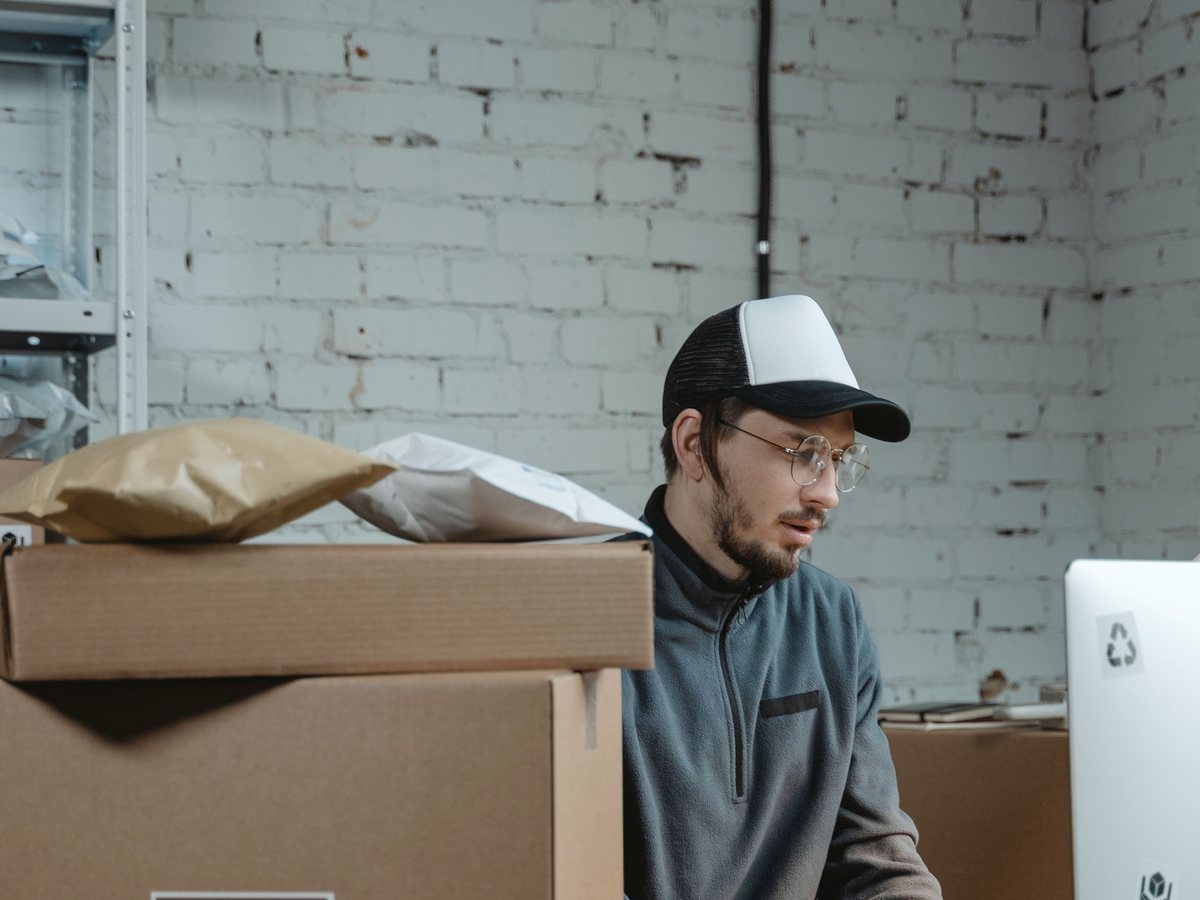 An ecommerce operator processing orders beside parcels